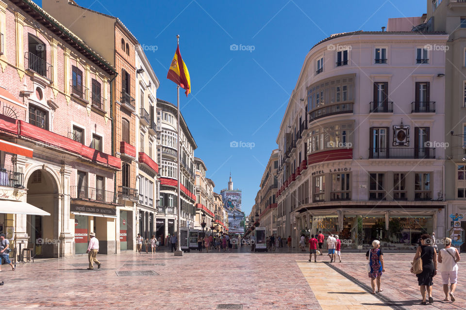 A square and pedestrian street in Malaga, Spain with people in a sunny day.