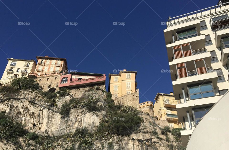 New building and old villas on a cliff