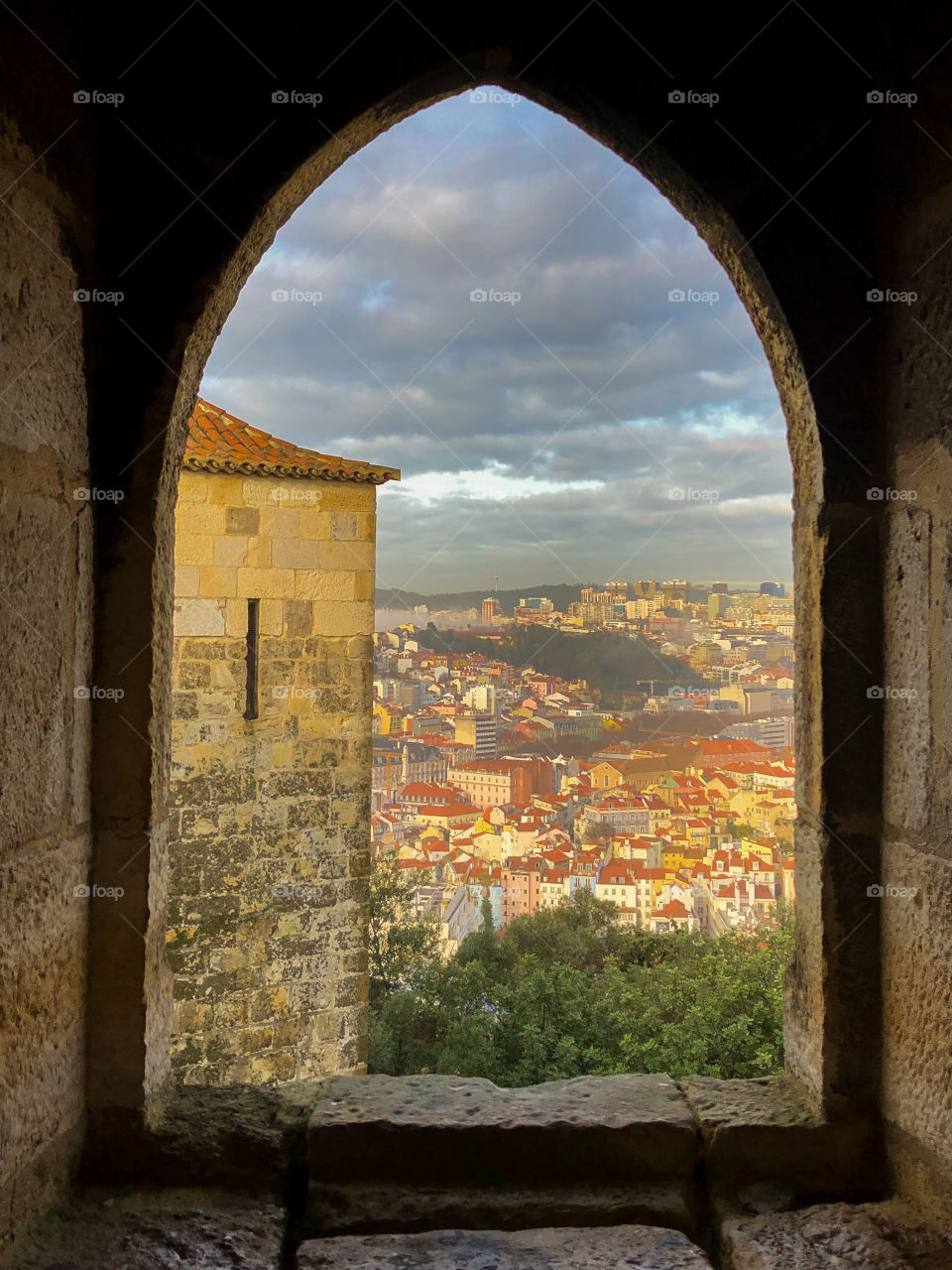 Looking out across the city of Lisbon as seen from within an old castle tower window