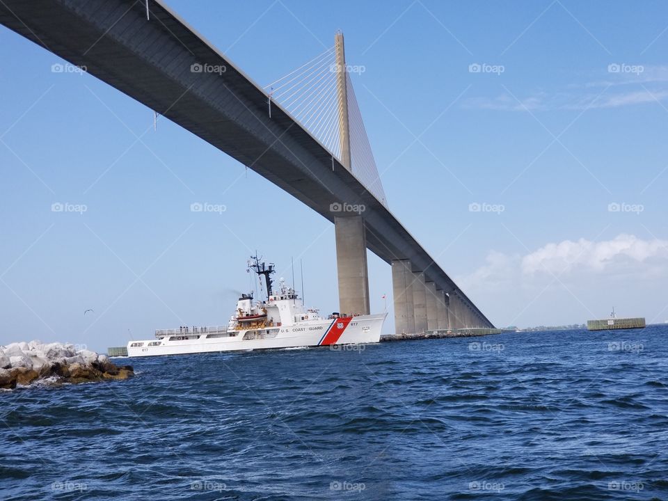 coastguard ship under skyway bridge