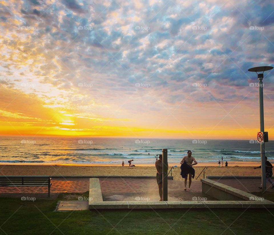 Beach shower at sunrise at Manly Beach 