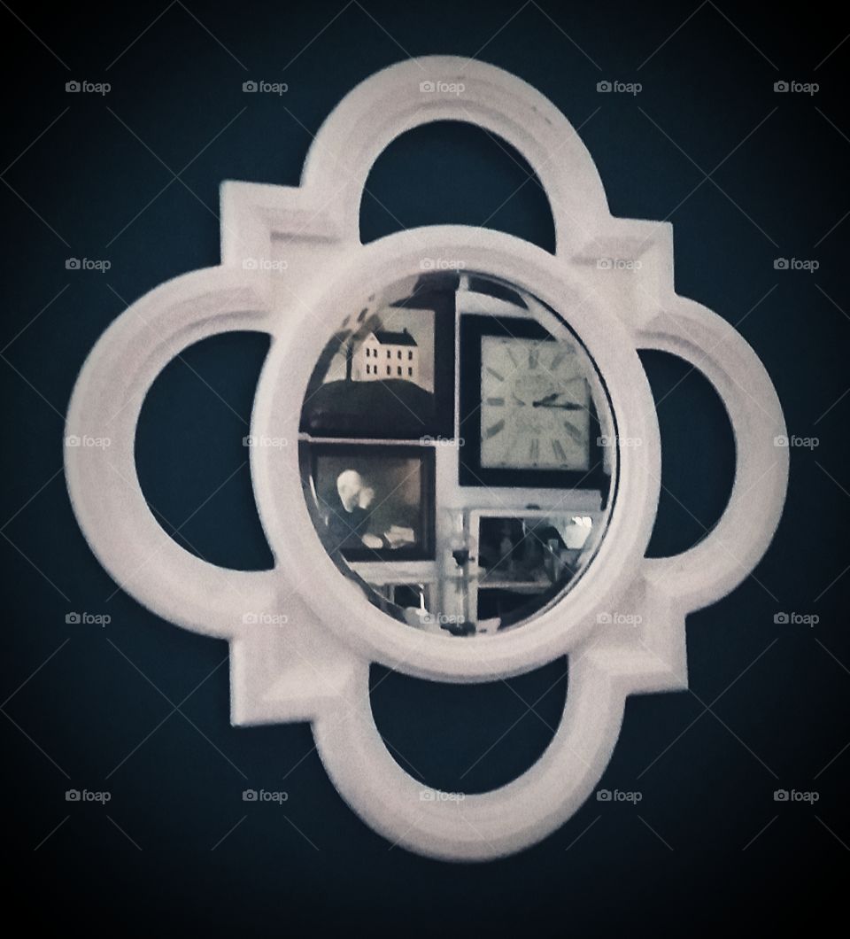 round mirror with  reflection of rectangular frames