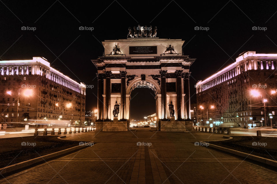 The arch is illuminated at night