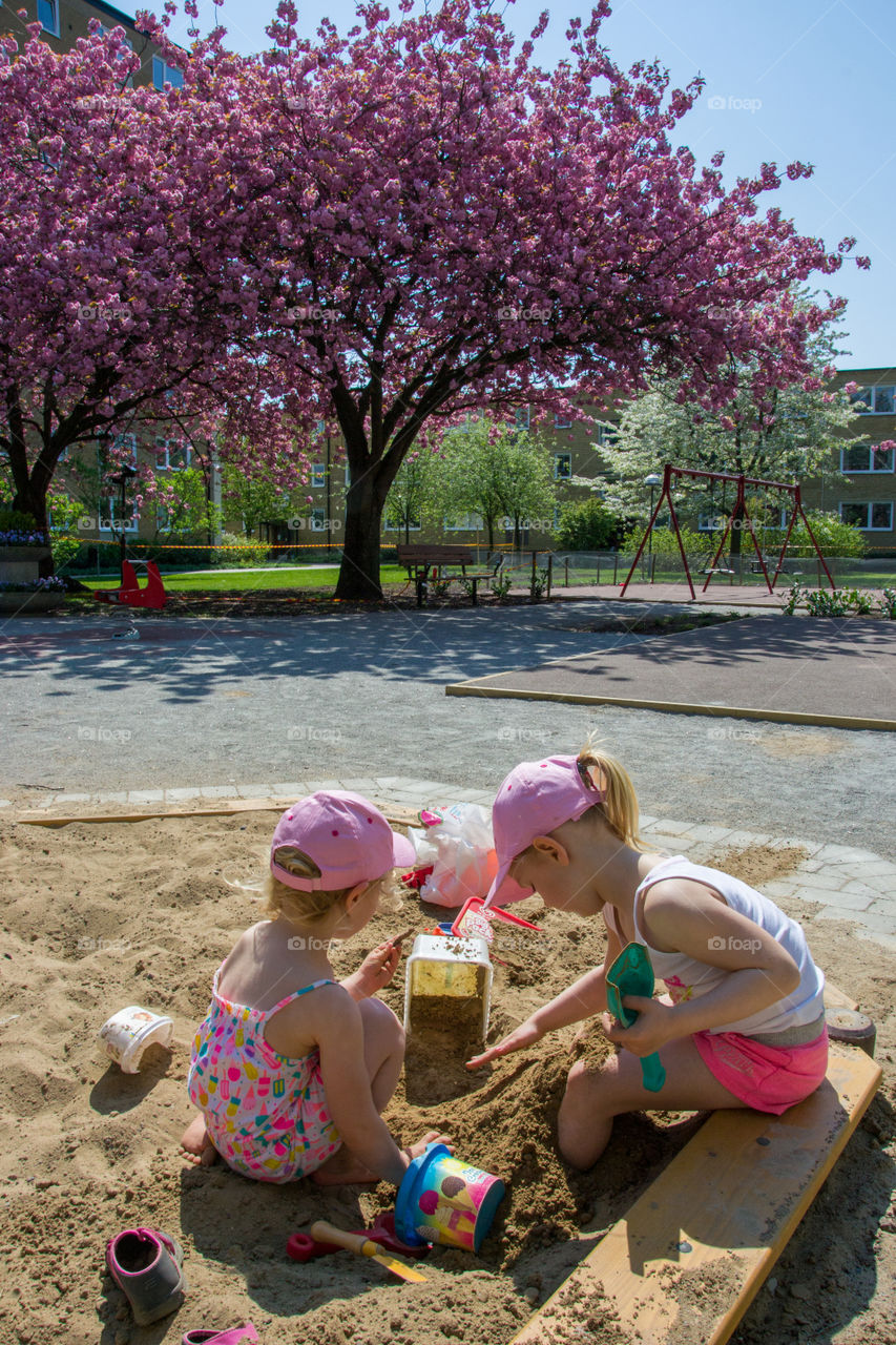 Two young sister is playing at a playground in Malmö Sweden.