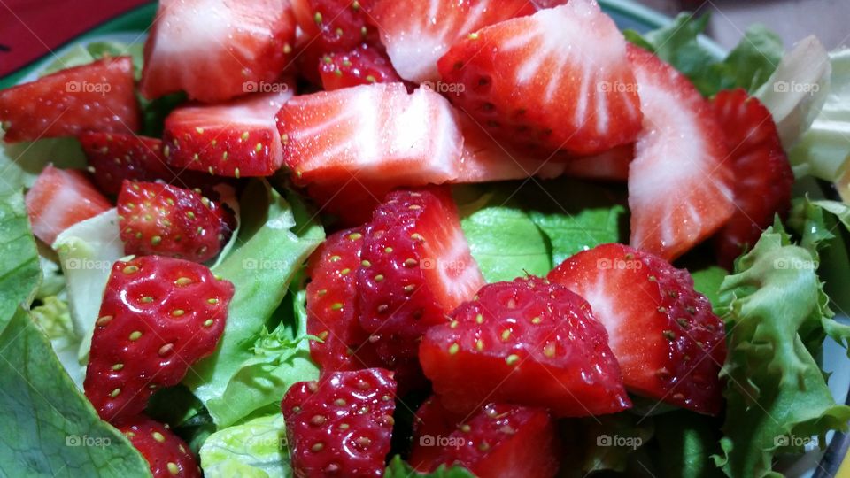 strawberry green salad. spring salad preparation with vegetable