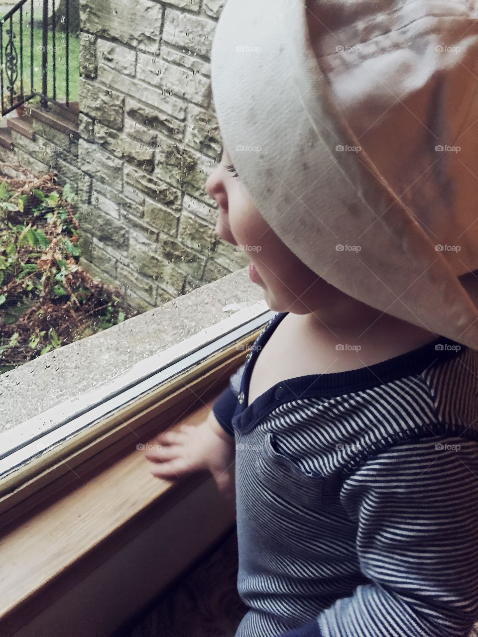 Close-up of baby looking through window