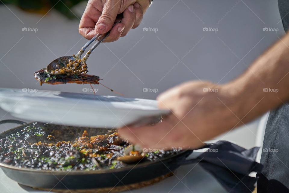 Close-up of person's hand serving food