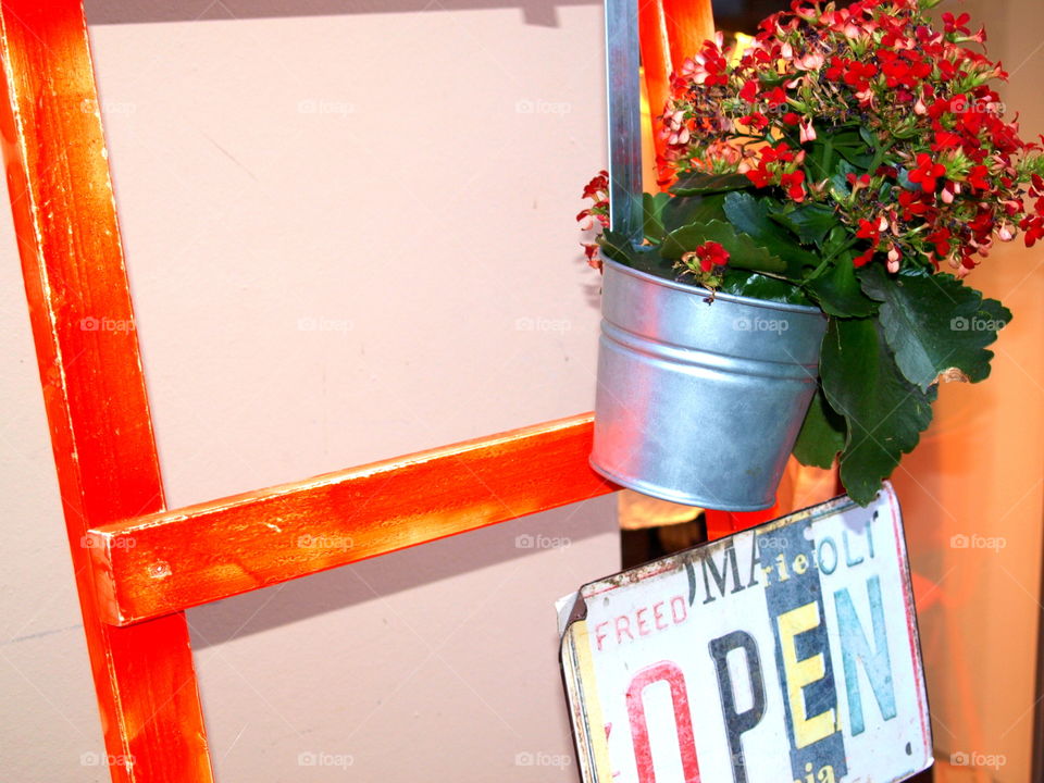flowers with a sign and red stairs