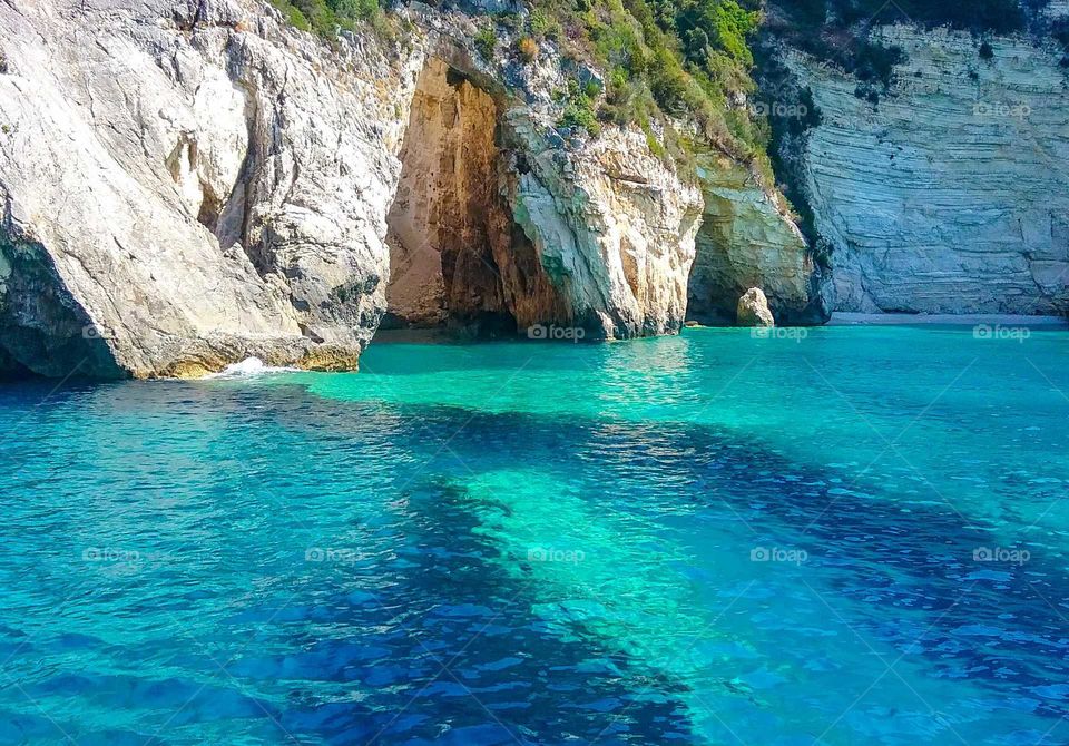 Turquoise sea in a cave opening Paxi, Greece