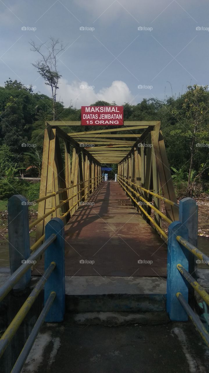 a bridge with a notice max 15 person