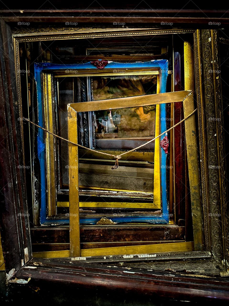 Multiple used/discarded wooden frames in a vintage/antique store