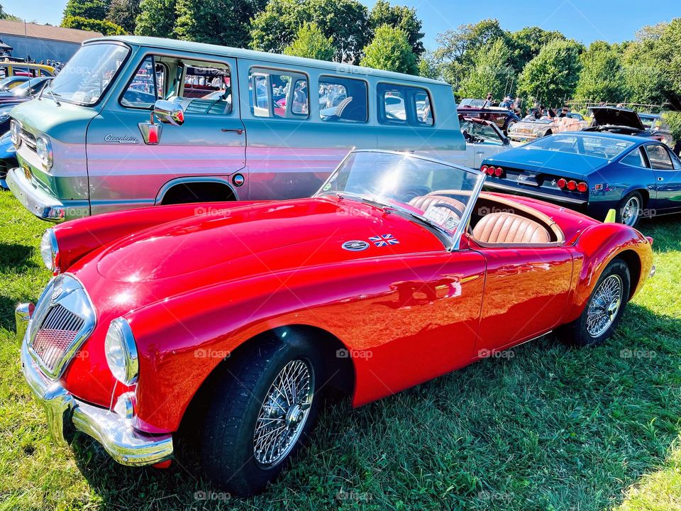 The MG. Red two door sports car, sleek and elegant. Appealing to the eye. 