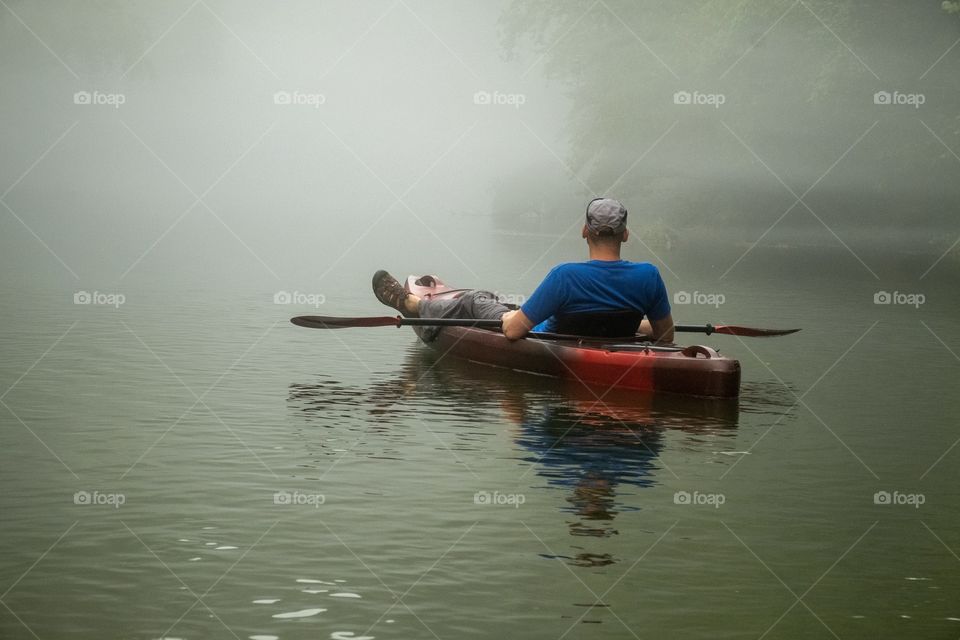 Leisurely kayaking down the river on a foggy morning. Foap, Hobby Time. 