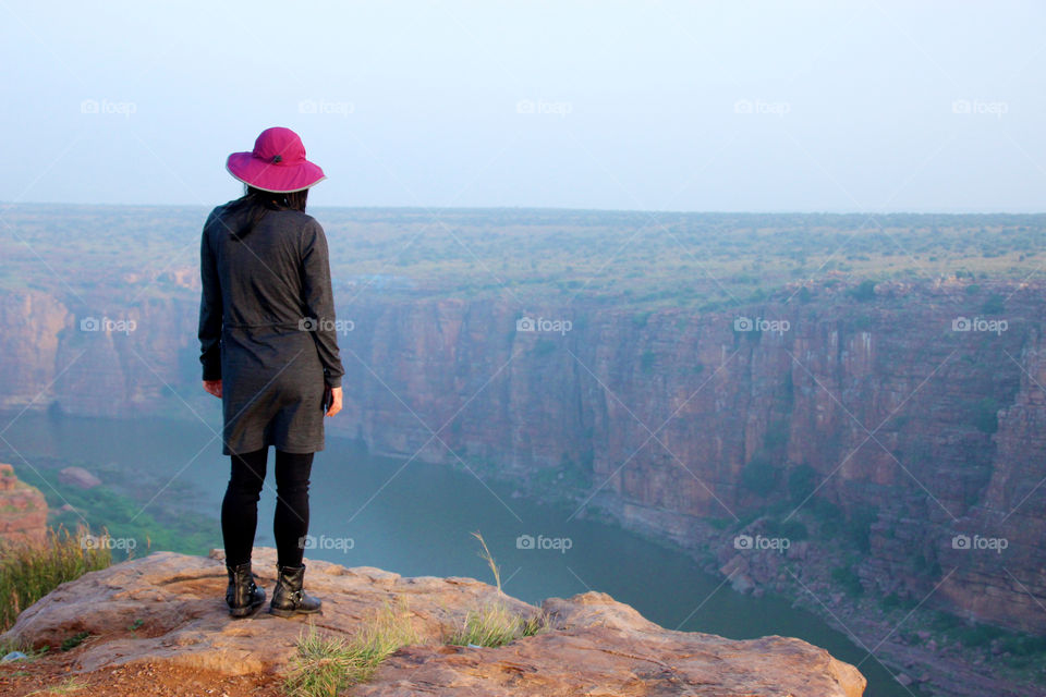 Girl standing on the Rock edge, adventures woman