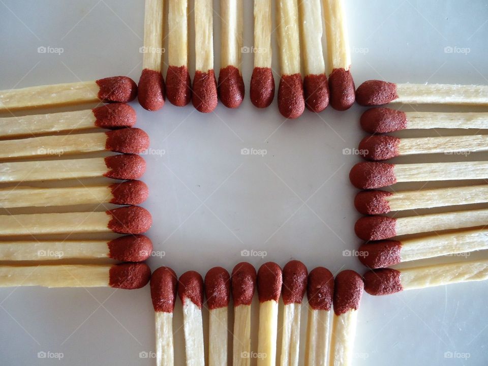 square matches with red head and wooden stick body