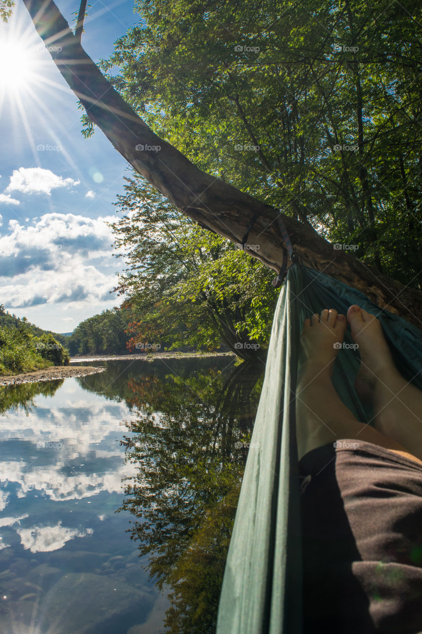 Take some time to relax in a hammock on the side of a calm river