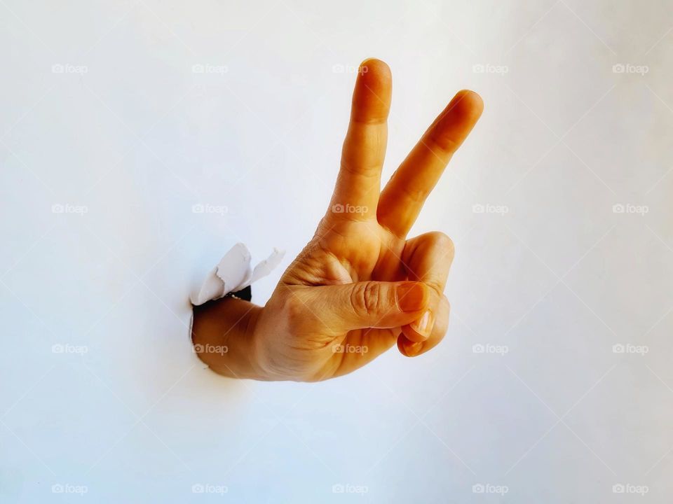 close-up of hand ok gesture on white background
