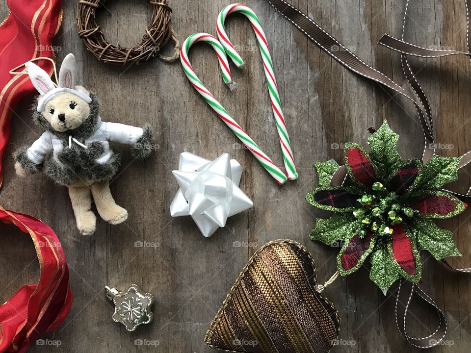 Rustic wooden Christmas flat lay with brown, red and green decorations 