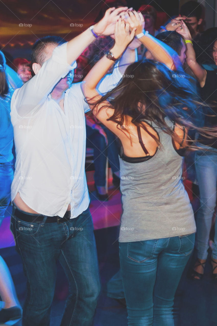 Couple dancing salsa in the night club 