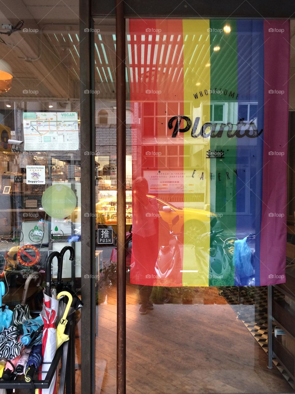 A welcome rainbow-colored flag at the front door of a vegan restaurant Plants in Taipei, Taiwan.
