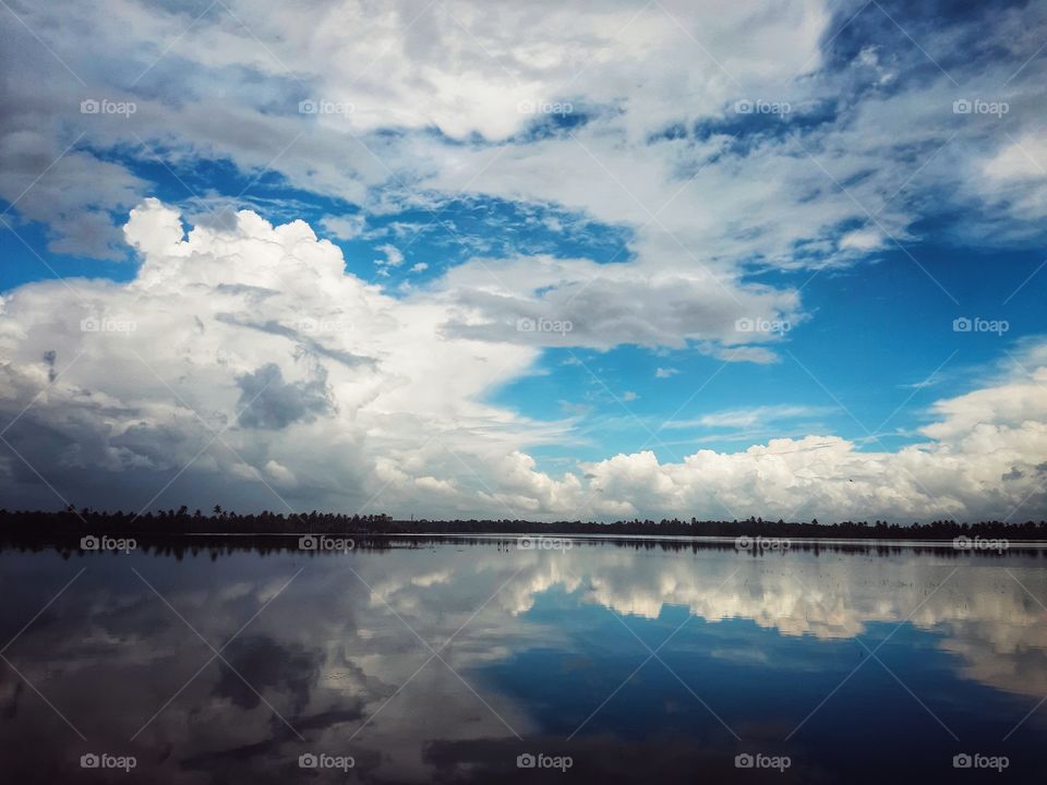 the water mirrors the cloudy sky as the beauty of nature.