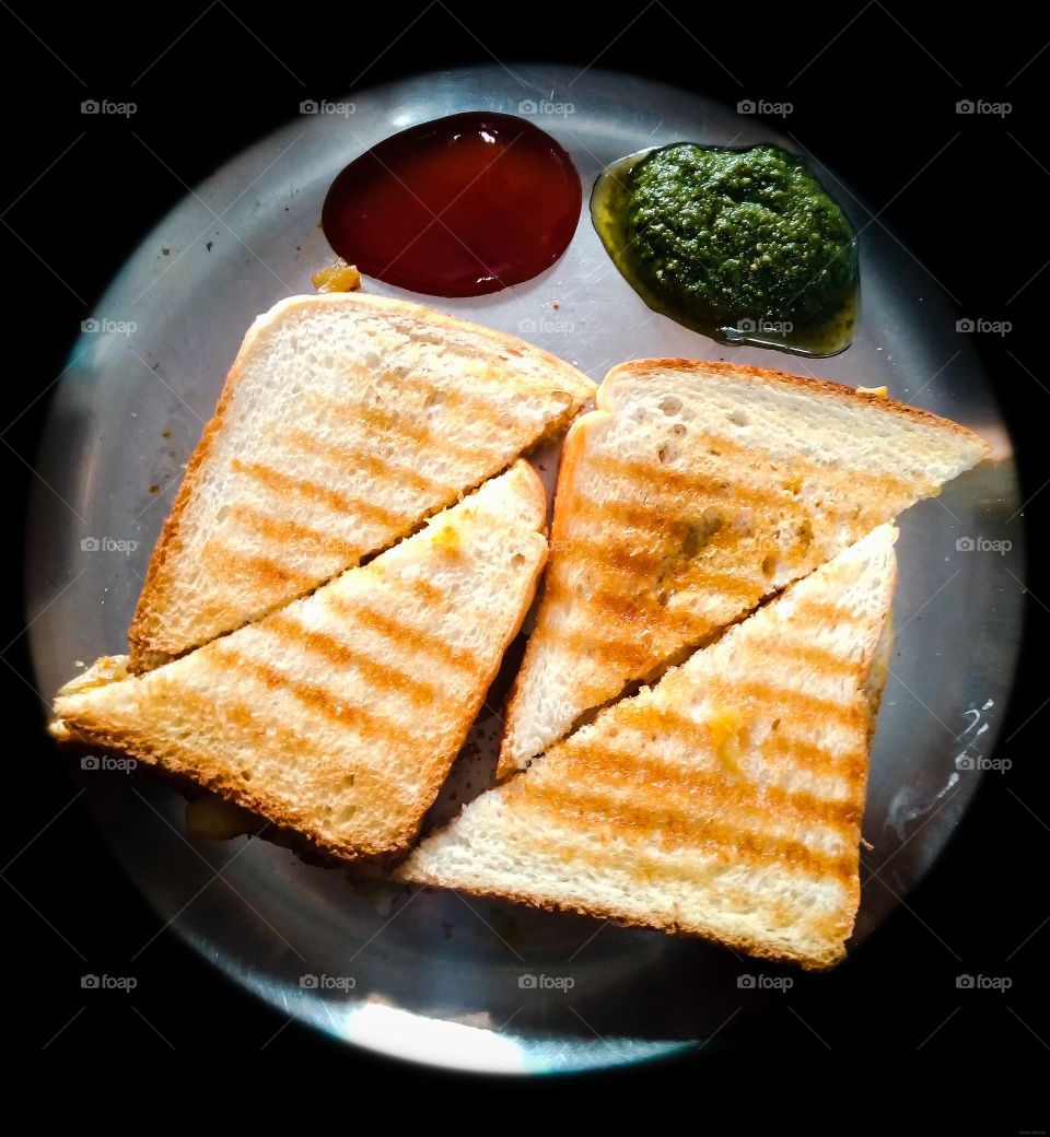 Homemade Grilled Toast with sauce and green chutney.