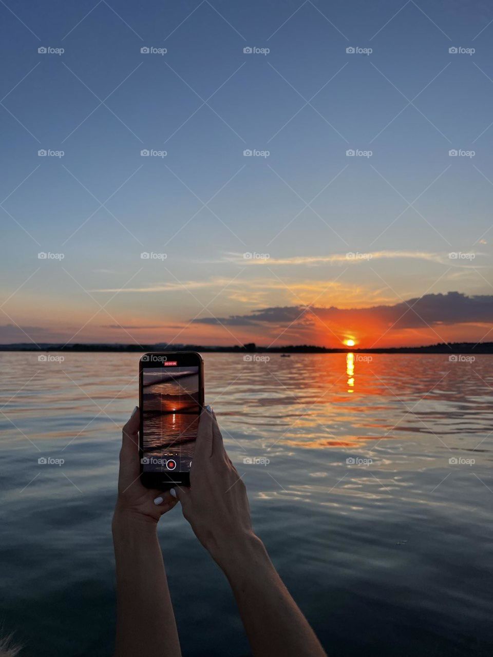 No camera can transmit the mirror reflection of clouds, sky and sunset, you need to see it live!