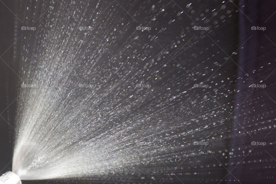 Spraying water dark background 