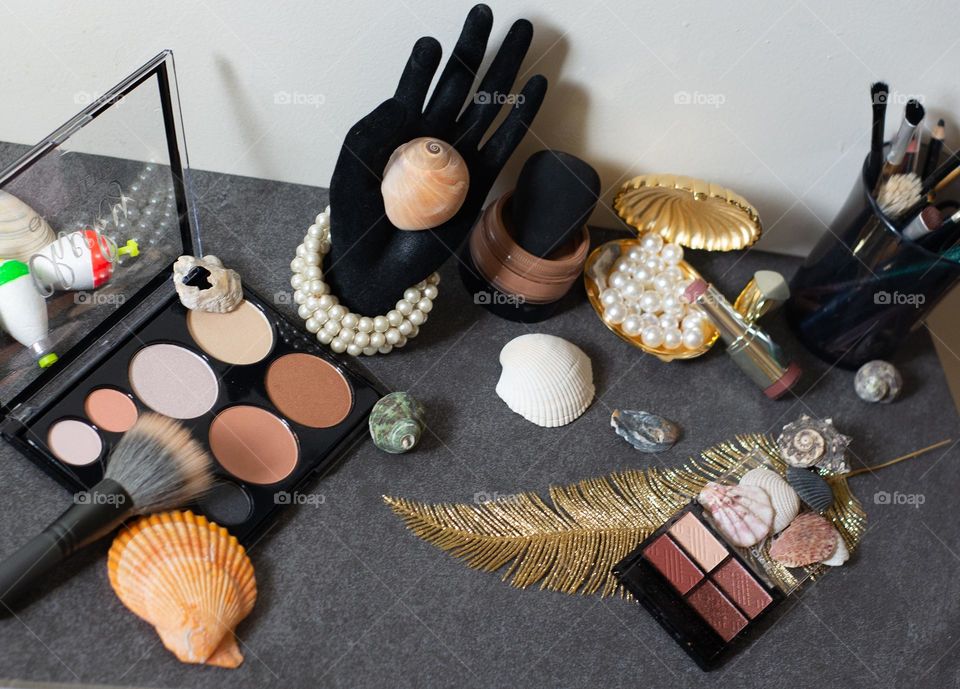 Shells,pearls,makeup and things on a slate backdrop 