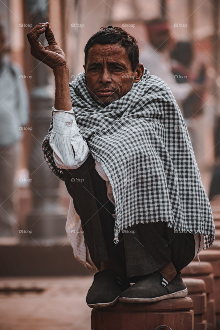 An Indian labour holding a cigarette