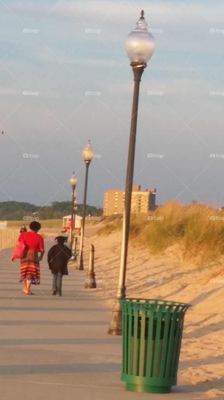 walk with me and you will learn many things. Aunt and niece enjoy stroll of beach and sand.  