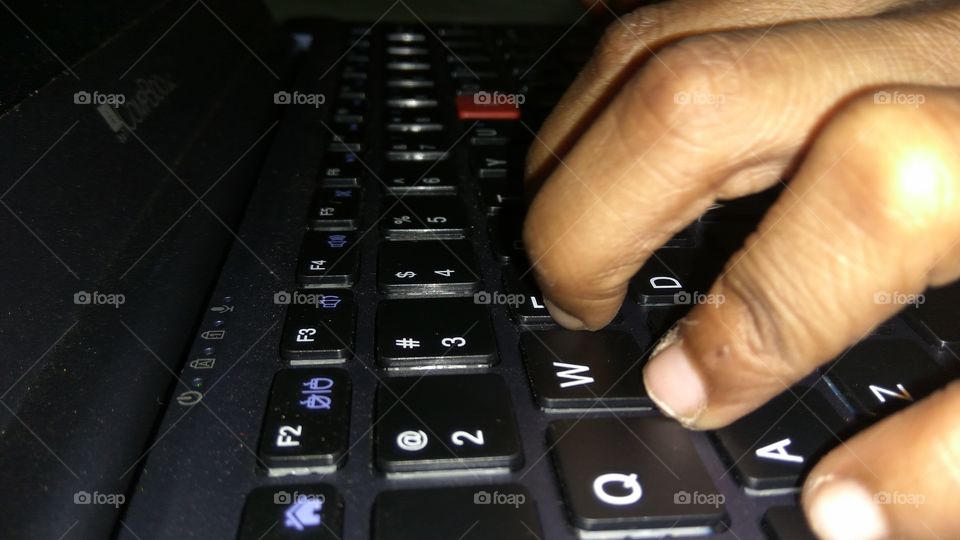 child operating laptop playing games