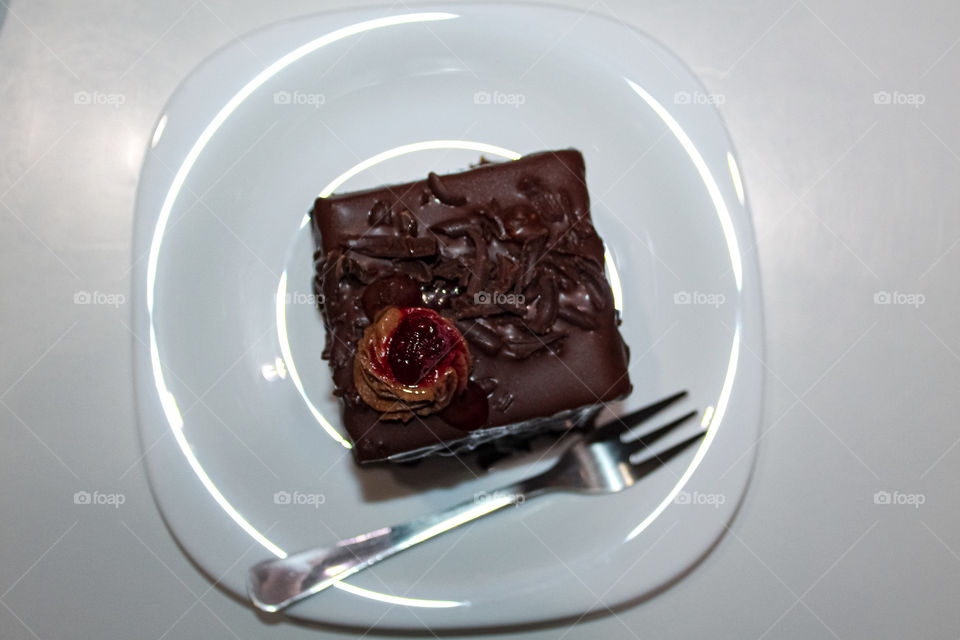 Chocolate mousse with raspberries on a white plate