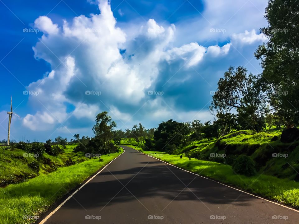 Way towards heaven.. Blue sky and Green earth meeting somewhere into heaven.. The way goes to Kas platue (Kas pathar) located in Satara city ,Maharashtra , India.. way towards valley of flowers.. famous tourism location in India..