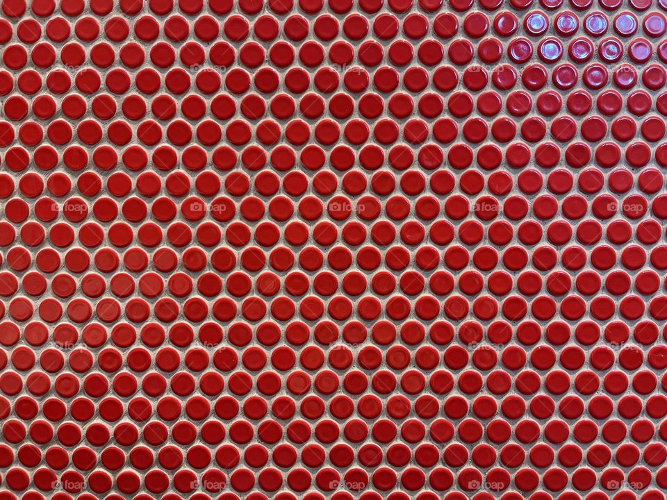 Circle red tiles on the wall 