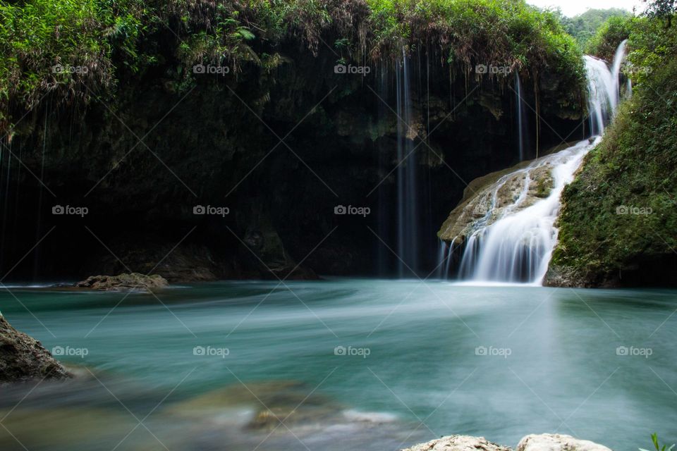 Long exposure shot of a flowing waterfall in the lovely place of Semuc Champey, Guatemala.