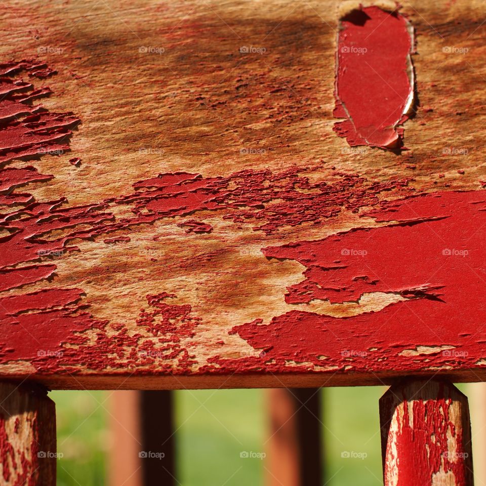 Bright red paint peeling off of an old wooden chair makes for amazing texture. 