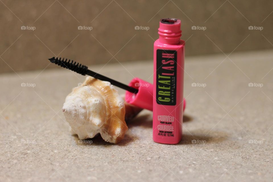 Maybelline Great Lash mascara pink container open showing brush resting on seashell