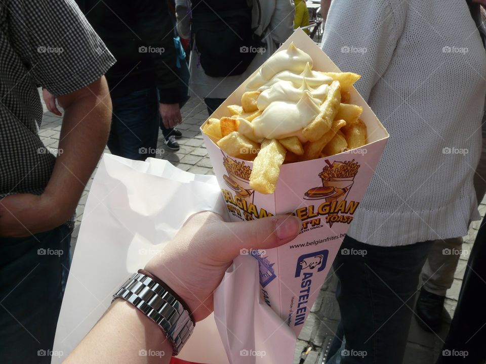 Takeaway French fries with mayonnaise on a street in brussels