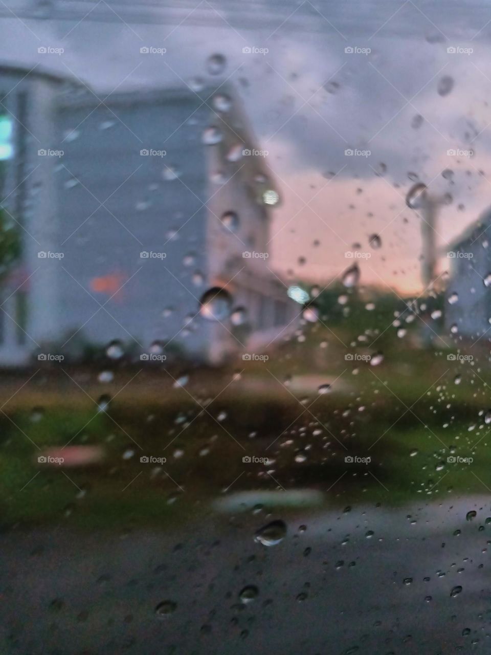 Selective focus on the rain drops on the windshield of the car. After rain at the rainy season