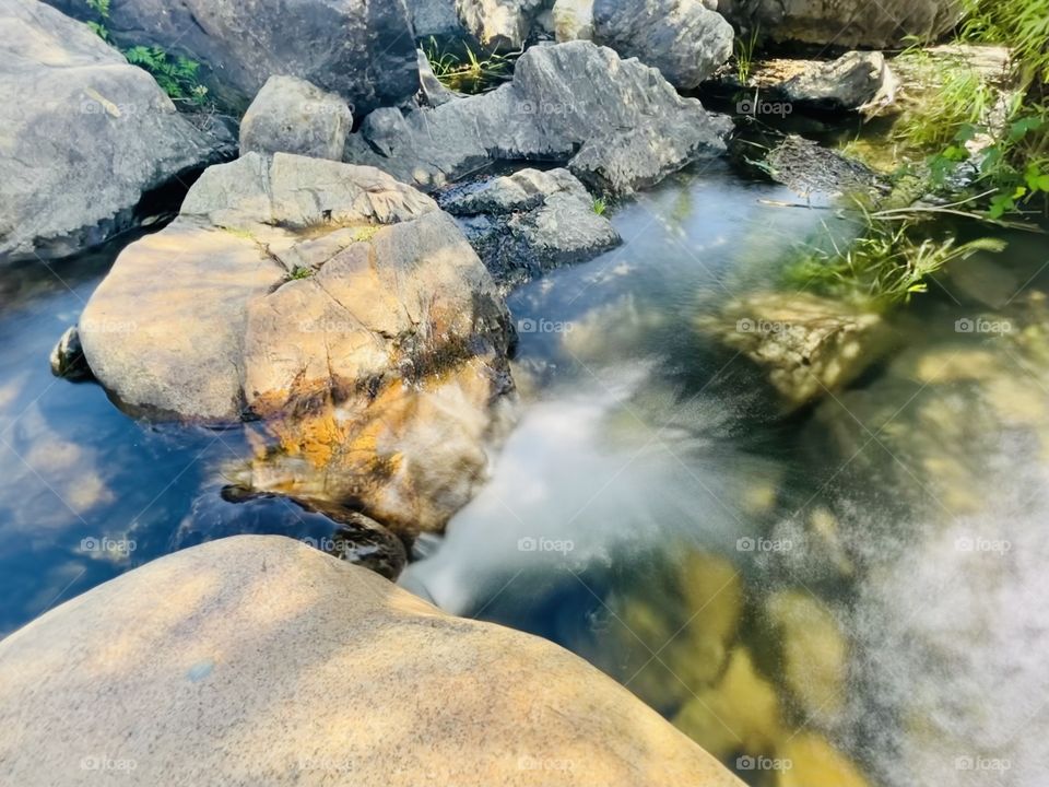 Water flow in the spring surrounded with rocks