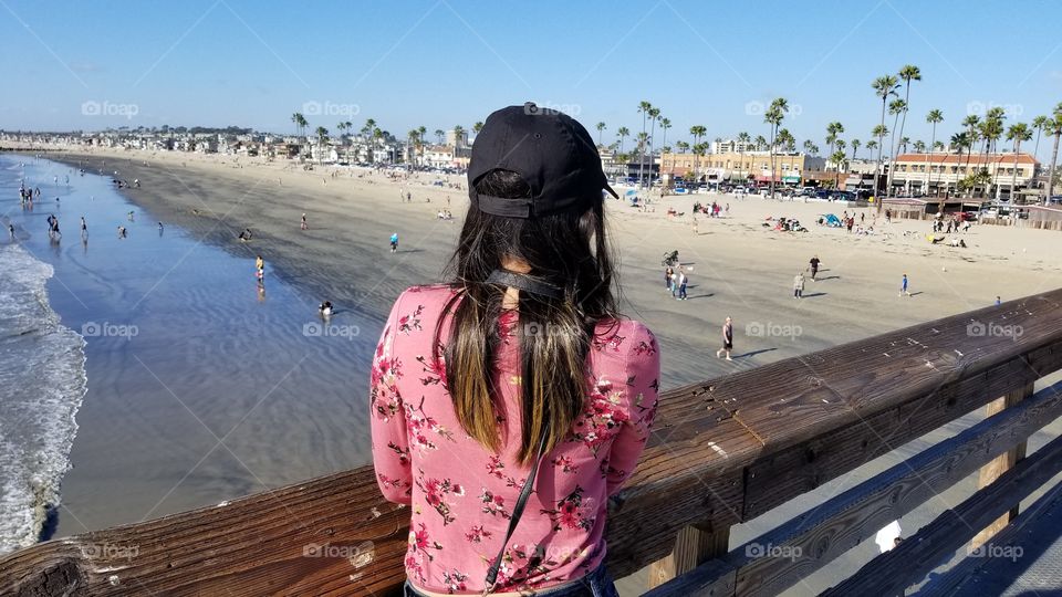 fashionable woman looking out the sea view of the ocean