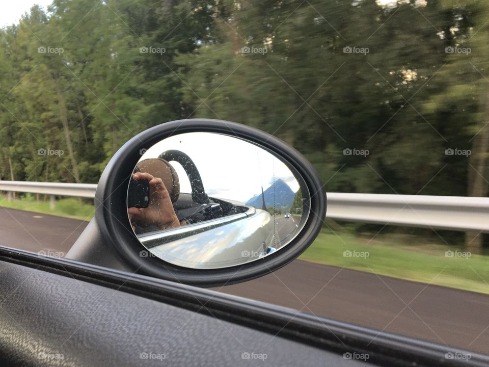 On the road with mountain in mirror