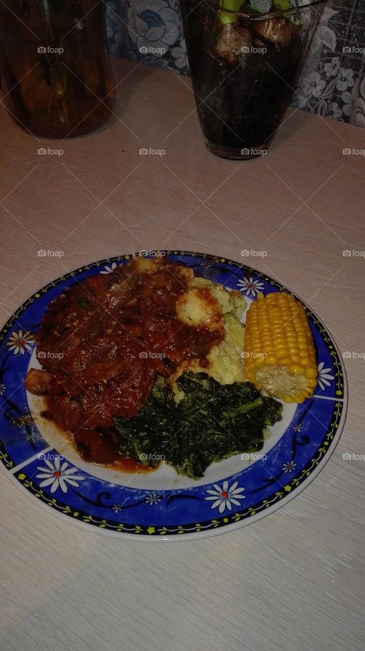 mash potato with spinache, sweet corn, and stew chicken