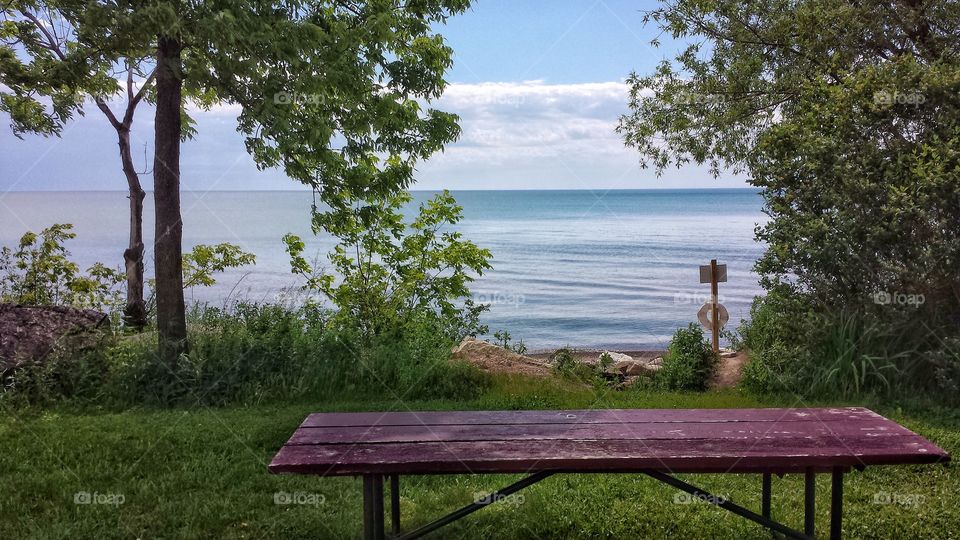 Empty bench against sea