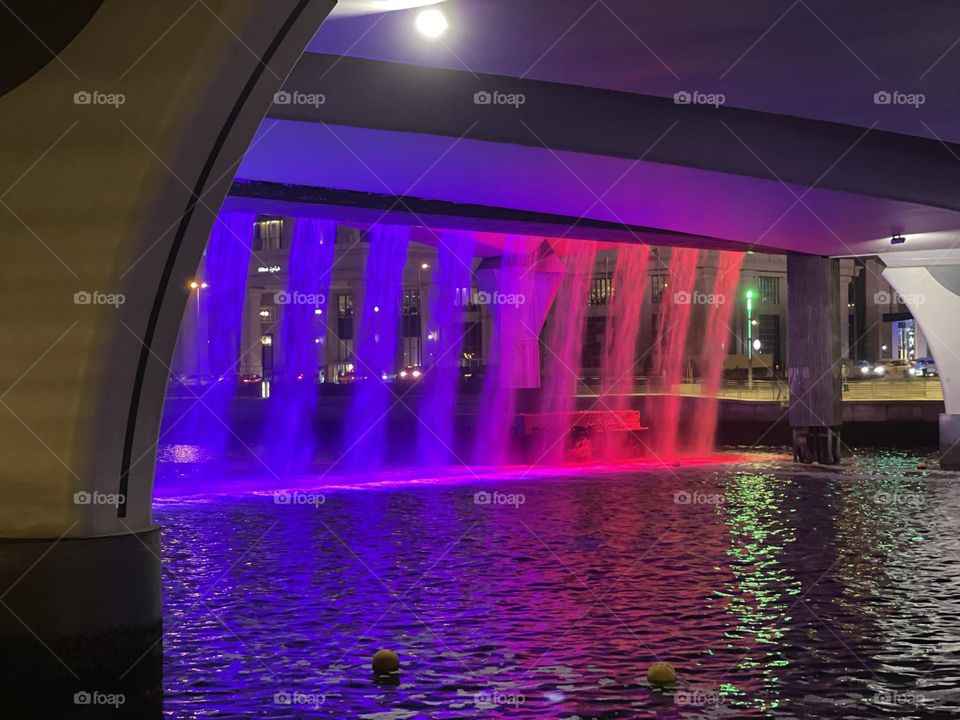 Purple water fountain under the bridge- Dubai