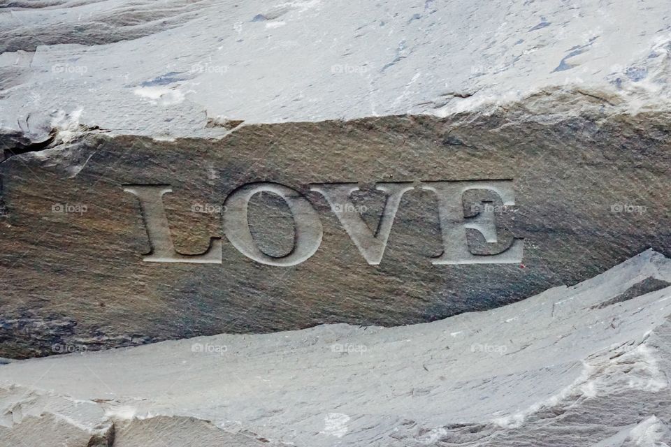 LOVE written in stone. Love chiseled in stone capitalised