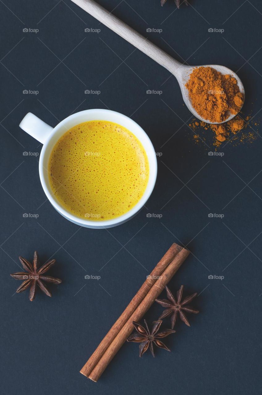 Top view to cup of golden (turmeric) milk.