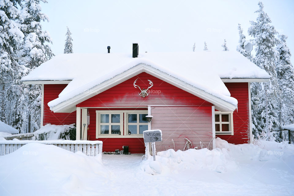 scenic red wooden cabin in the winter 

