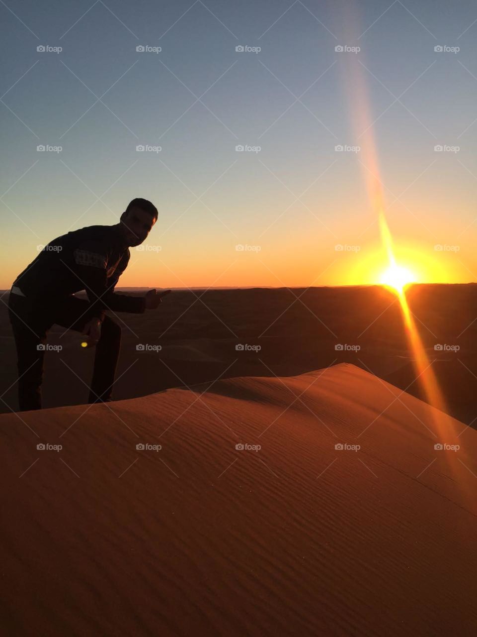 sunset and sand dunes in desert